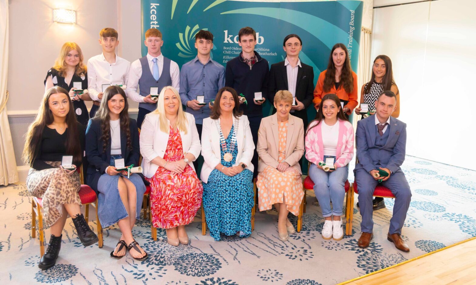 Standing: Dearbhla Ní Liatháin NíNualláin of Gaelcholáíste Cheatharlach, Keelin Byrne of Coláíste Aindriú, Adam Kinsella of Coláiste Eoin, Conall Tobin of Grennan College, Kieran Crowley of Scoil Aireagail, Christian Germaine of Tyndall College, Eibhlín Holden of Coláiste Cois Siúire, Caoimhe Hickey of Coláiste Mhuire Seated: Aimee Dunne of Duiske College, Róisín Ní Shúilleabháin of Coláíste Pobail Osraí, Pauline Egan, Director of Schools KCETB, Cllr Andrea Dalton, Chairperson, KCETB, Eileen Curtis Chief Executive KCETB, Niamh Cuddihy of Abbey Community College, Éoghan Grennan of Borris College