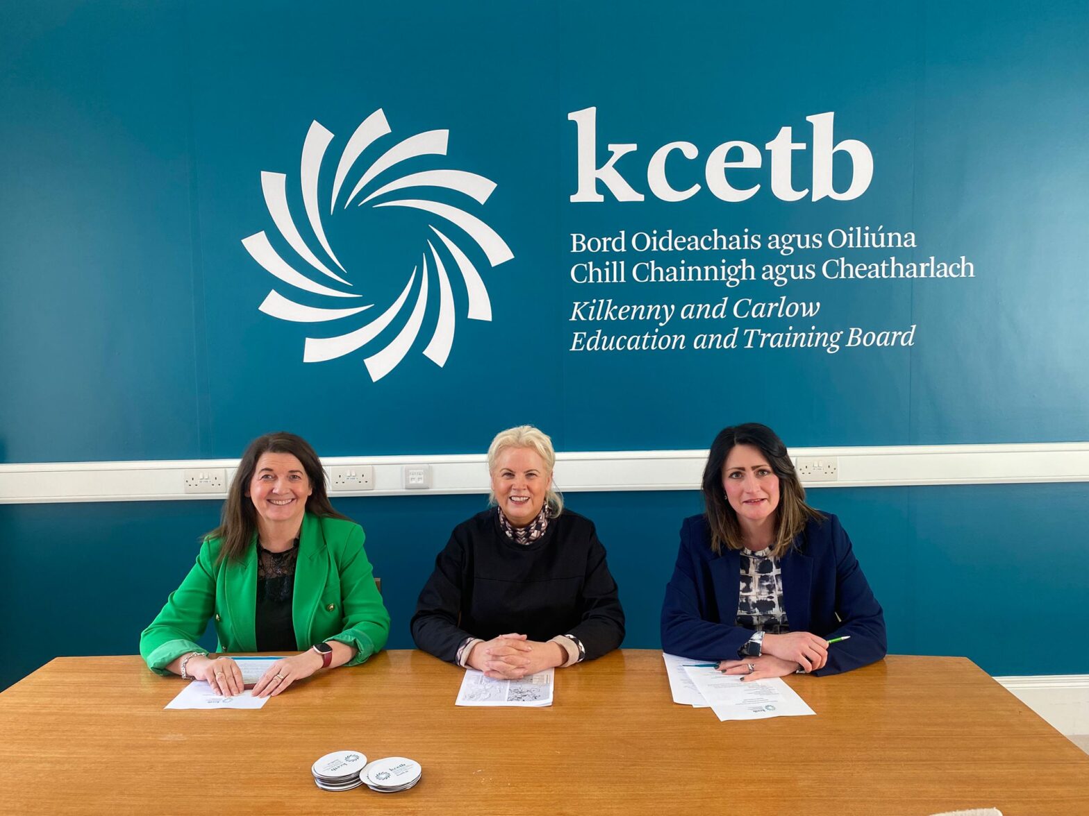 Three people sitting at table