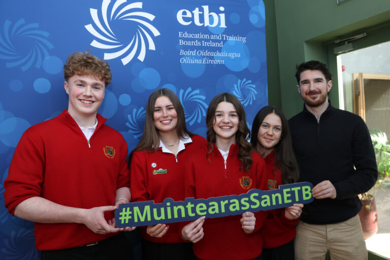 Students in red uniform holding banner