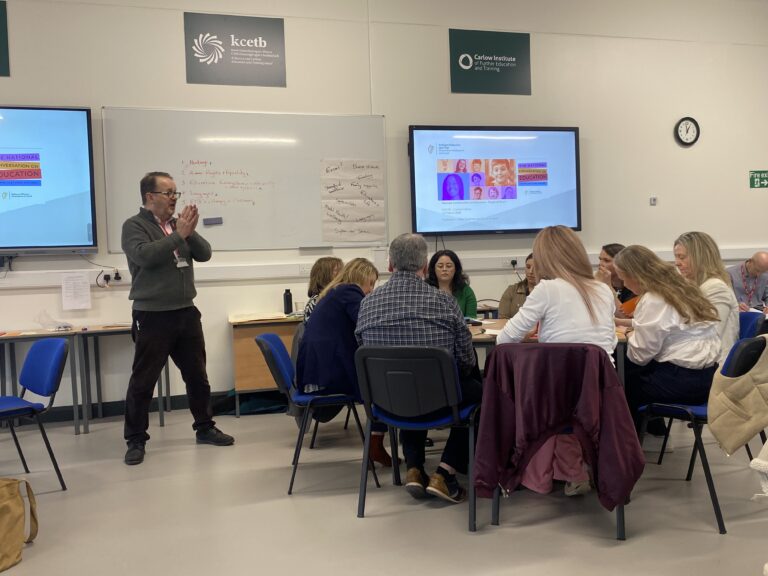 People seated in a group with facilitator